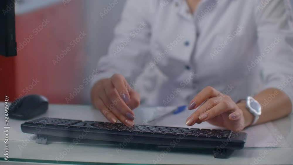 Womans doctor hand typing on laptop keyboard. Womans doctor hand typing on laptop keyboard.