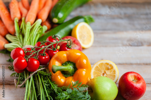 Concept of clean eating, healthy food, vegetarian and vegan diet. Natural organic fruits and vegetables. Wooden background, close up, copy space, flat lay, top view