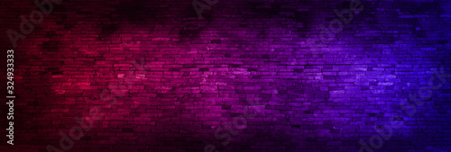 Panorama Neon light on brick walls that are not plastered background and texture. Lighting effect red and blue neon background of empty brick basement wall.