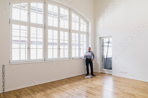 Man checking specifications of refurbished kuxury loft photo