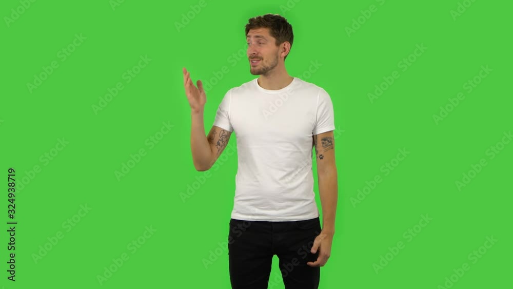 Confident guy is talking and pointing side hand for something, copy space.. Green screen Confident guy is talking and pointing side hand for something, copy space.. Green screen