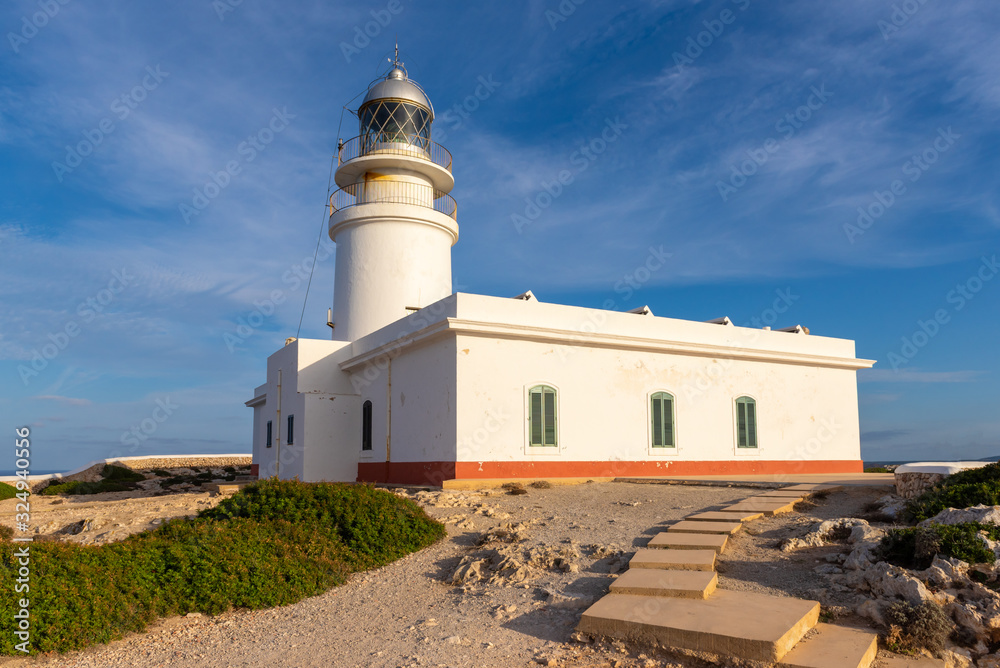 The white tower of Cavalleria lighthouse situated at the northernmost point of Menorca island. Baleares, Spain
