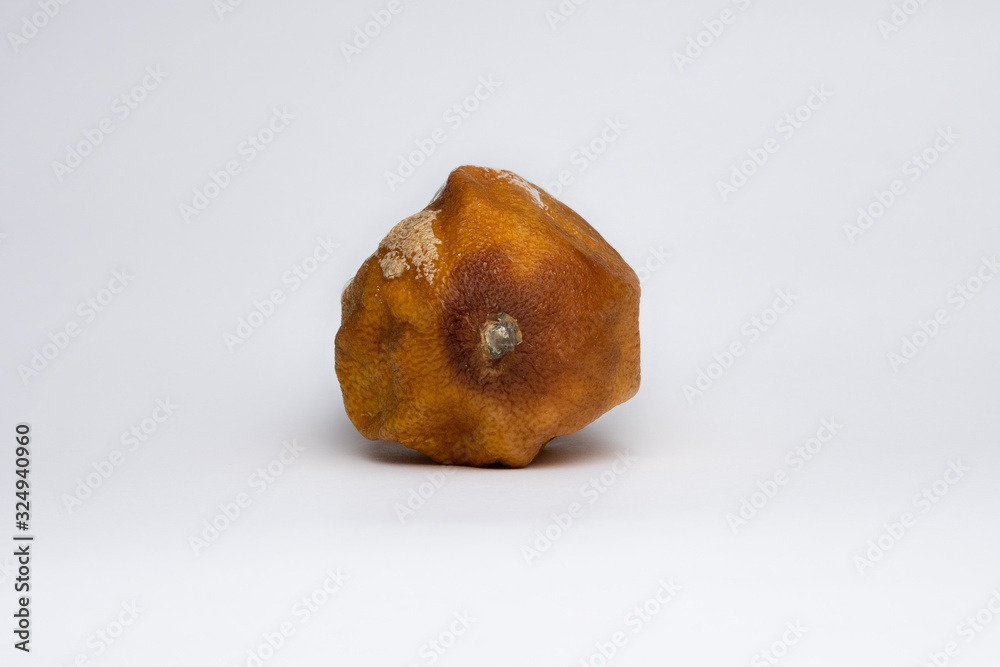 moldy lemon with wrinkled and dry peel on a white background lies tail forward moldy lemon with wrinkled and dry peel on a white background lies tail forward