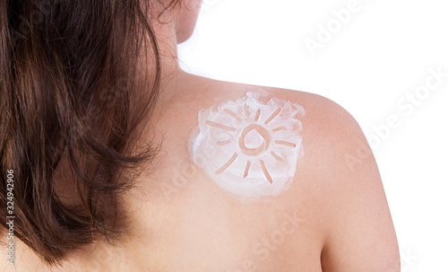 woman with sun shape from solar cream protection on the body