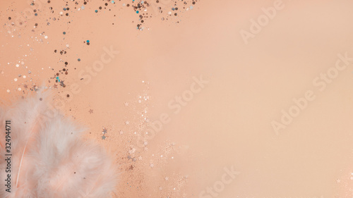 feathers on yellow background with glitters