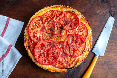 Directly above view of eggplant and tomato pie on wooden surface