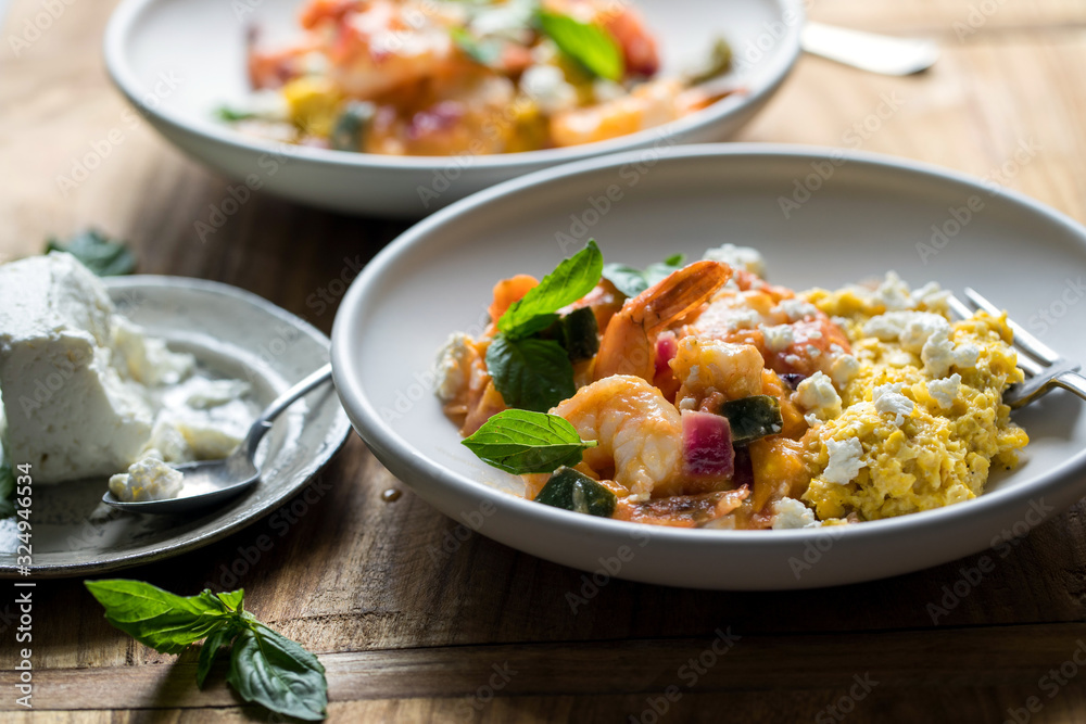 Selective focus of sauteed shrimp with creamed corn and feta Selective focus of sauteed shrimp with creamed corn and feta
