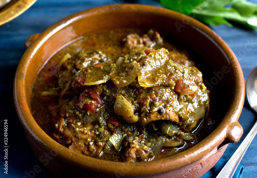 Close up view of coriander cumin chicken served in bowl photo