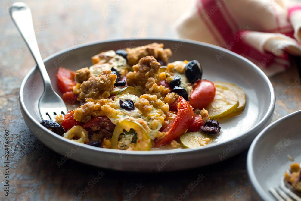 Close up view of tomato and zucchini casserole with oats and cheddar Close up view of tomato and zucchini casserole with oats and cheddar