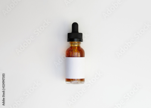 Closed medicine bottle with dropper isolated on white background.little dropper bottle. Top view.
