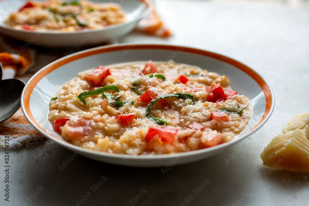 Close up of tomato and basil risotto served in bowl Close up of tomato and basil risotto served in bowl