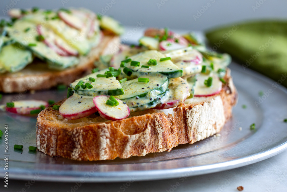 Selective focus of salad topped with cucumber and radish in plate Selective focus of salad topped with cucumber and radish in plate