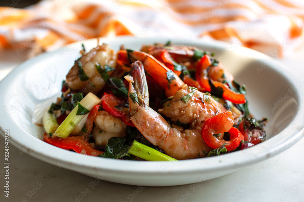 Stir fried shrimps with amaranth, red pepper and cilantro in bowl