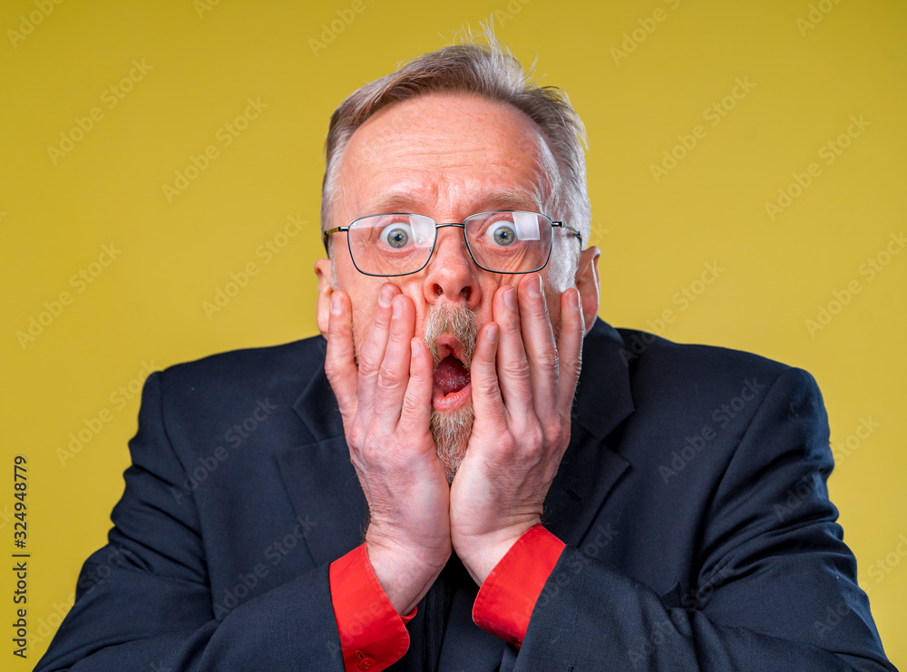 Surprised shocked middle aged man, hands near his face. Human emotions concept Surprised shocked middle aged man, hands near his face. Human emotions concept