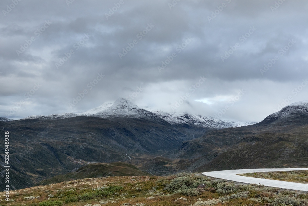 Mountain asphalt road, snow peaks Norway landscape