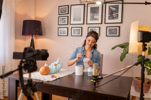 Vlogger recording video about baby formula milk preparation © Impact Photography
