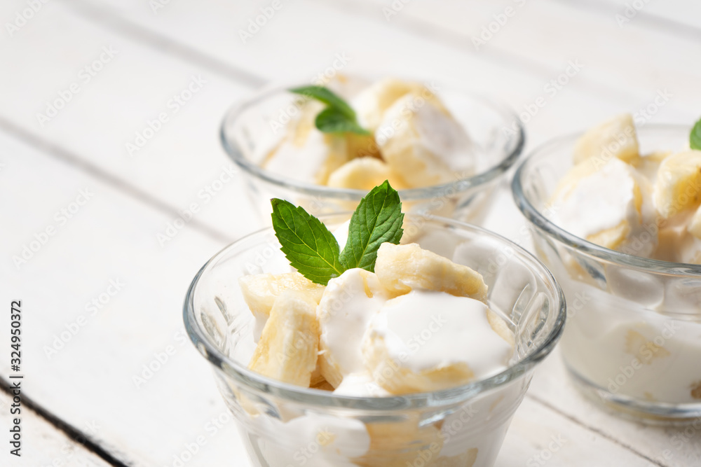 Banana with sour cream on white background Banana with sour cream on white background