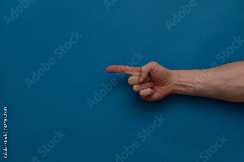 Hand pointing gesture on a blue background