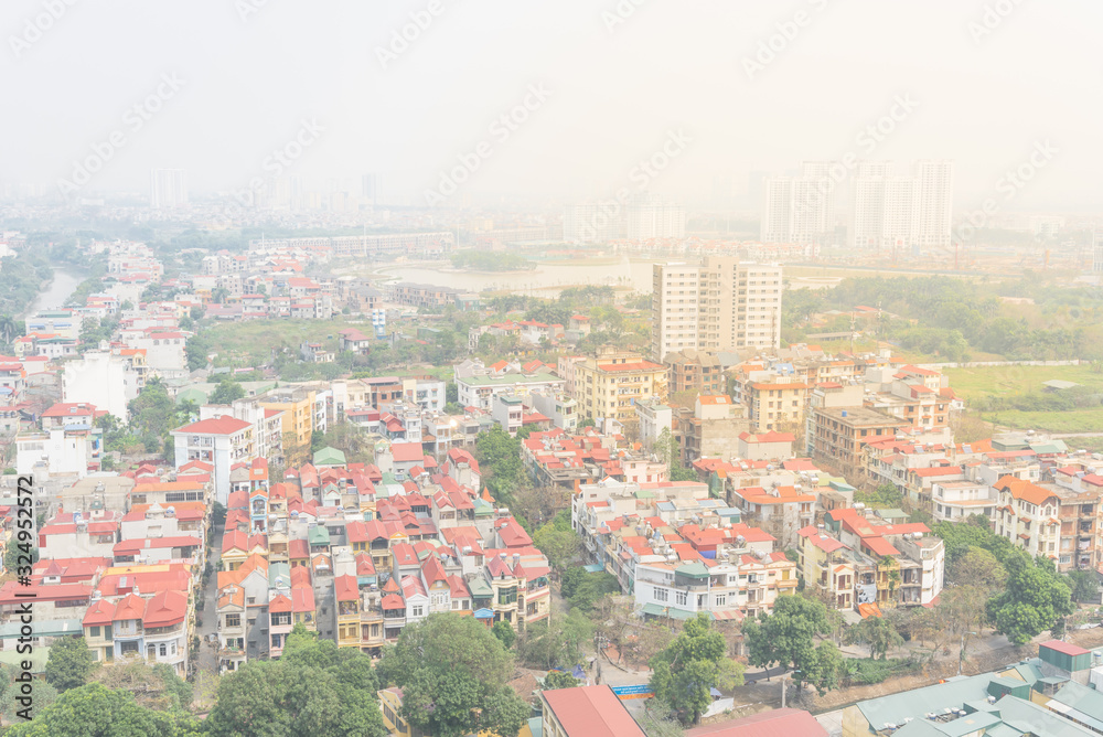 Aerial view residential houses and high-rise condominium building in foggy background