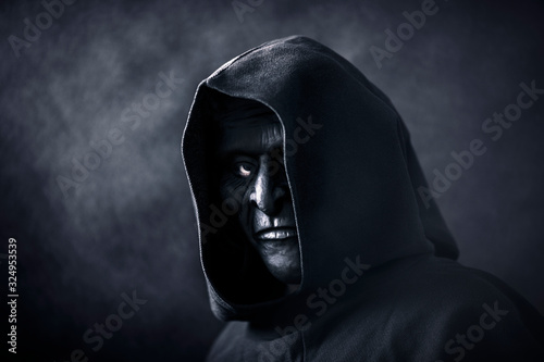 Tableau sur toile Scary figure in hooded cloak with mask