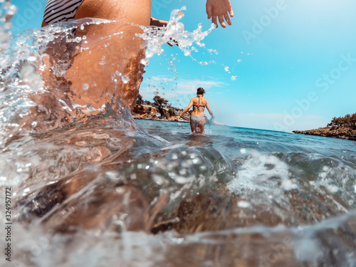 Woman entering into the sea