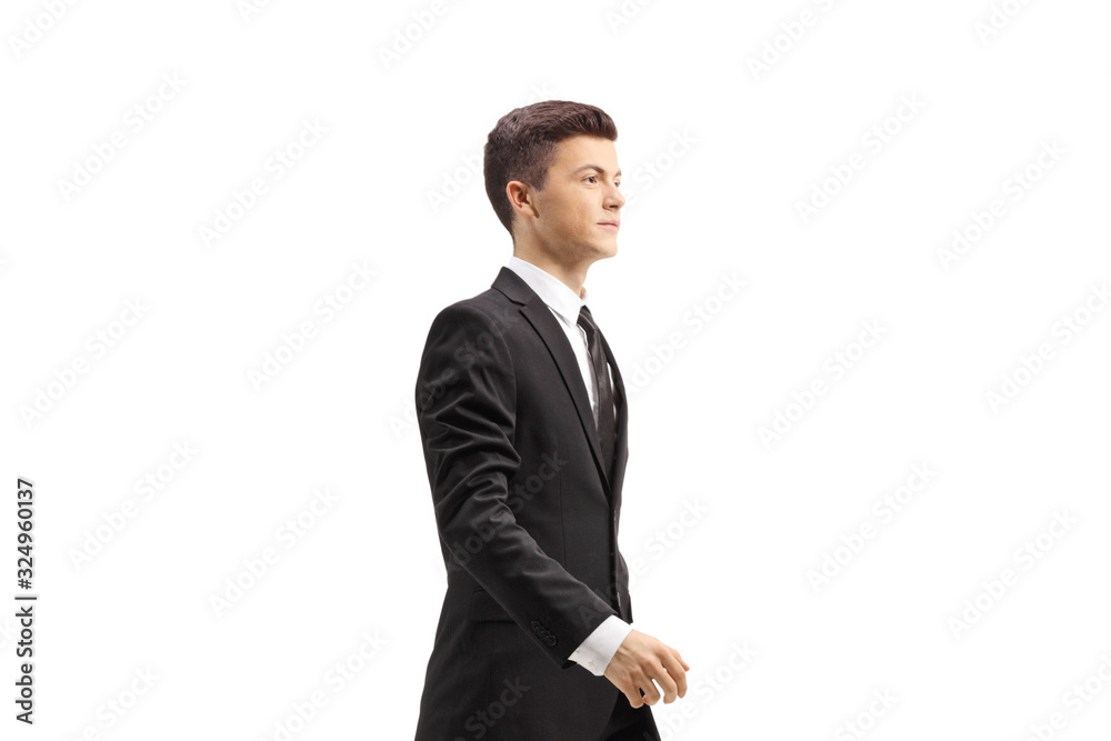 Young handsome man in a black suit walking Young handsome man in a black suit walking