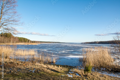 View of a frozen lake from a high bank