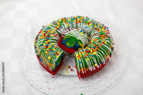Chocolate pound cake with rainbow frosting topping