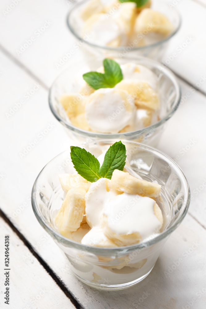 Banana with sour cream on white background Banana with sour cream on white background
