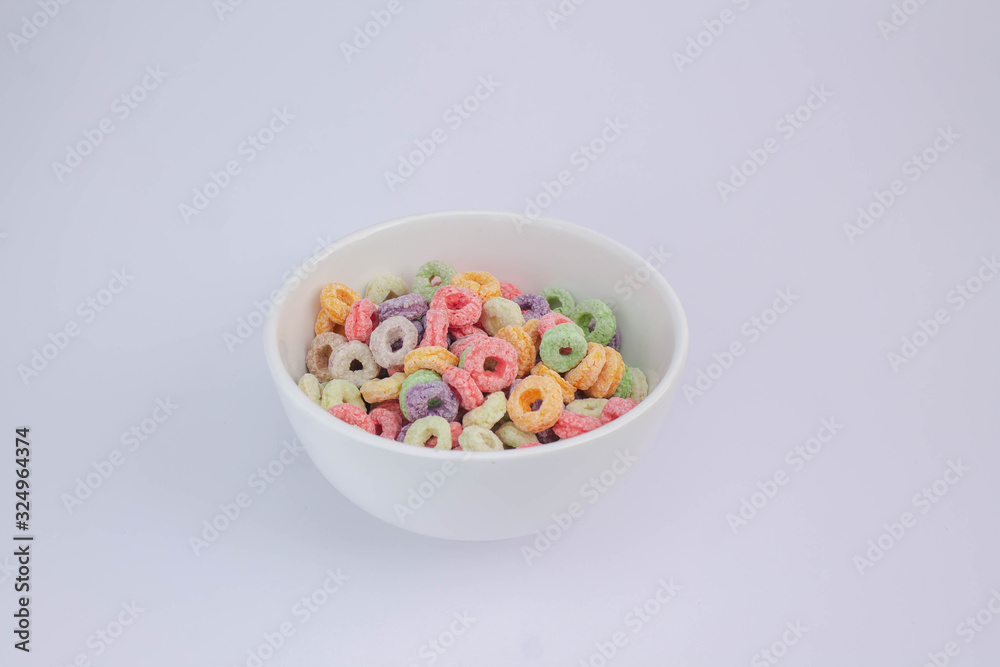 Fruit cereal in white cup on white table Fruit cereal in white cup on white table