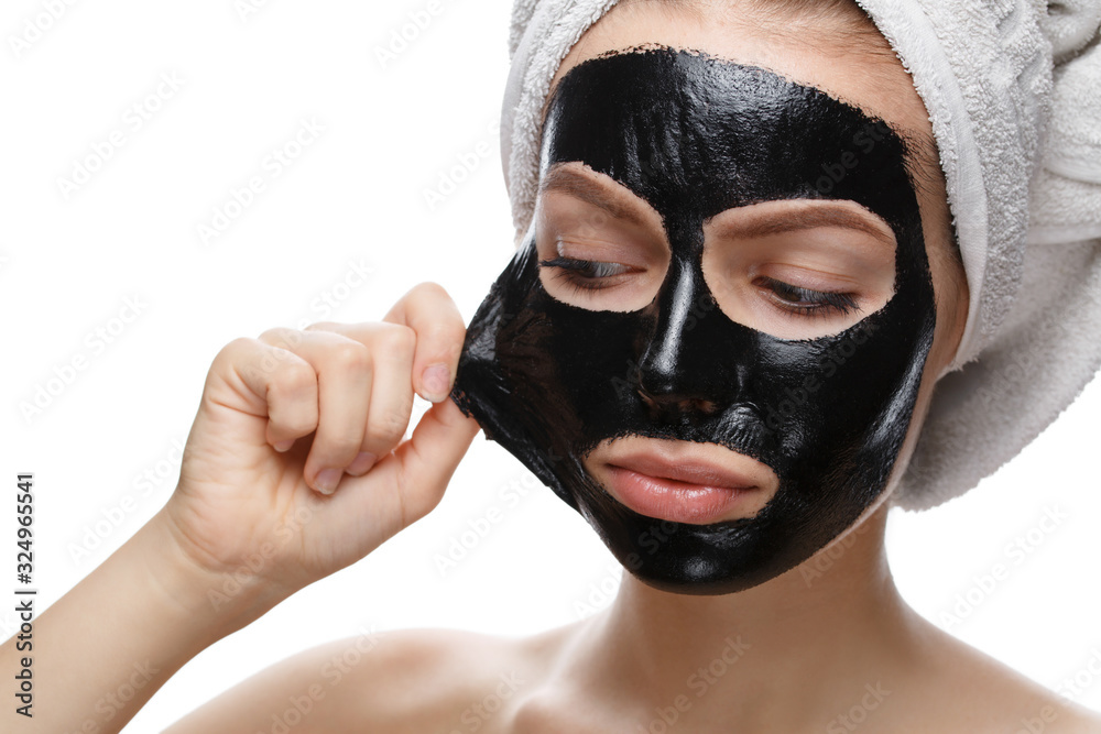 girl takes off black cosmetic mask from her face Stock Photo | Adobe Stock