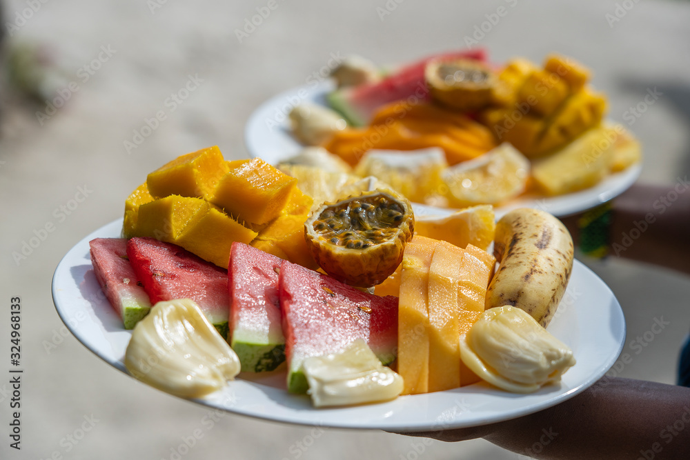 Tropical fruits on a breakfast plate, close up Tropical fruits on a breakfast plate, close up