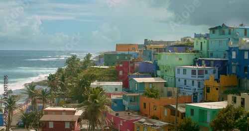 Wide angle establishing shot of colorful coastal homes in La Perla Puerto Rico