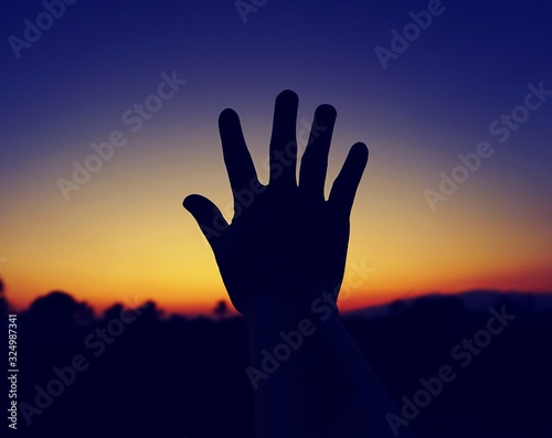 silhouette of hands in the sky
