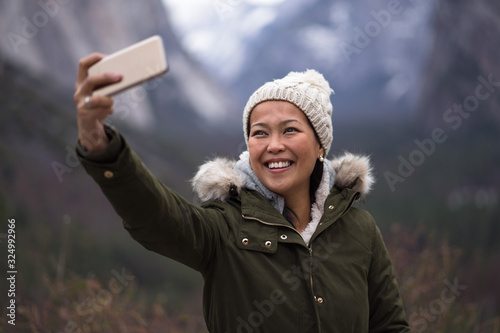 Smiling Young Woman Tourist Taking Selfie During Yosemite Winter