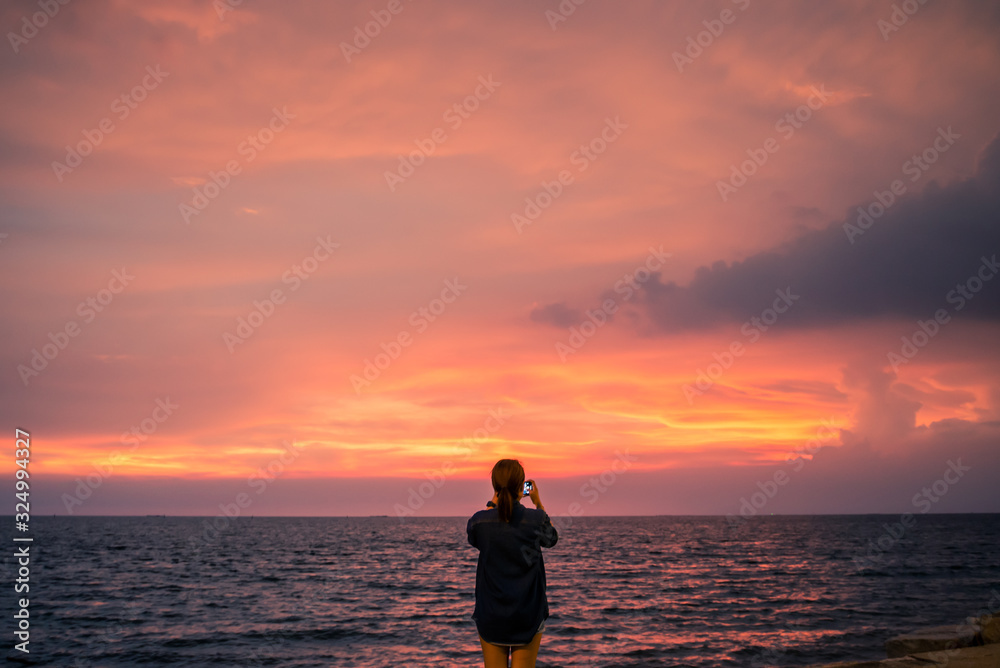 silhouette of a woman standing on the beach