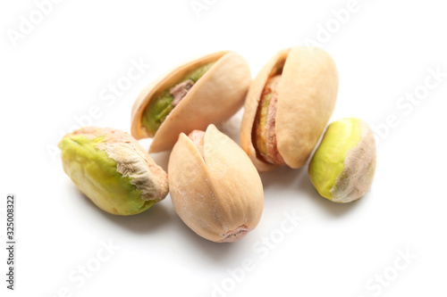 Tasty pistachio nuts on white background