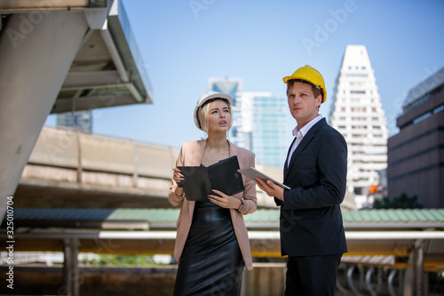 two architects working on construction site
