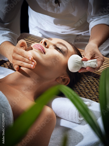 portrait of young beautiful woman in spa environment.   photo