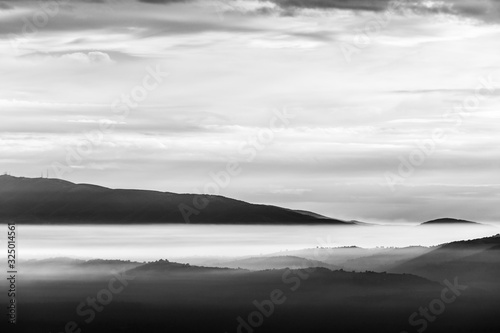 Fog filling a valley in Umbria (Italy), with layers of mountains and hills