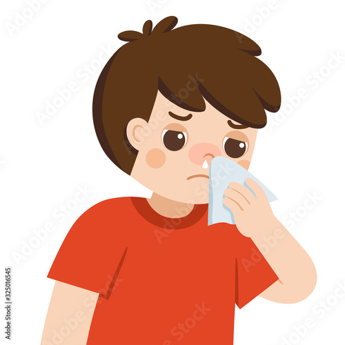 Sick cute boy with a cold and runny nose getting paper napkin sneezing. Flu symptoms.