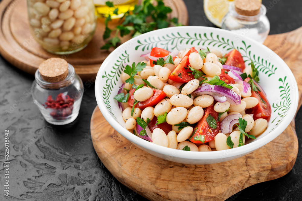 White bean salad with cherry tomatoes, red onion and parsley. White bean salad with cherry tomatoes, red onion and parsley.