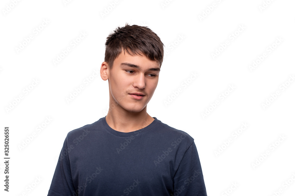 Shot of the young boy teenager of the brunette wearing blue shirt, isolated Shot of the young boy teenager of the brunette wearing blue shirt, isolated