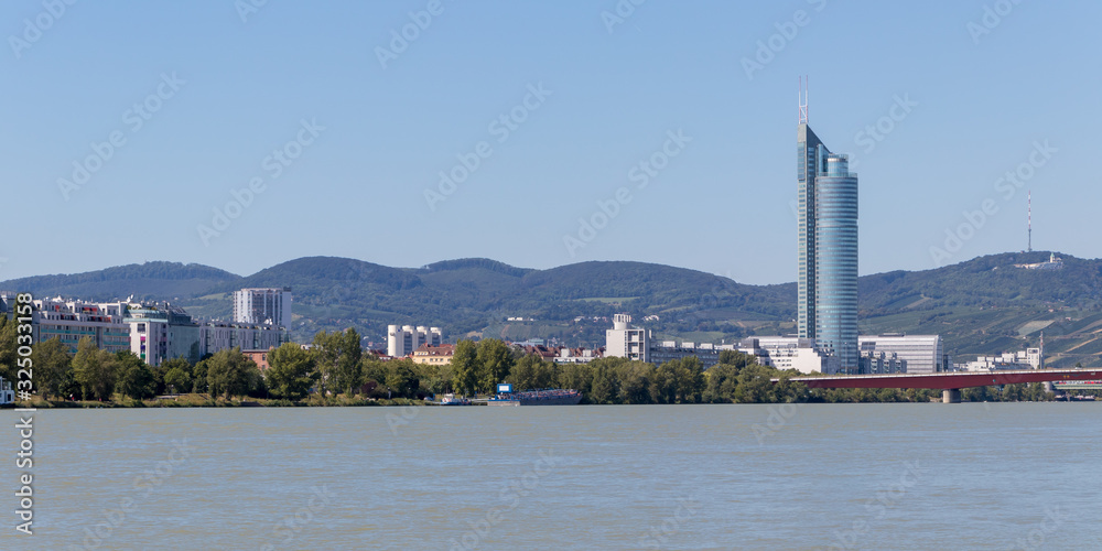 Vienna, Austria - September 4, 2019: Millennium Tower 50 story skyscraper at the Danube. Modern tower block overlooking downtown Vienna.