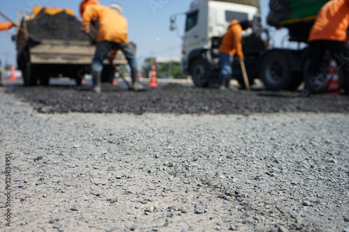 Blur image, repairing pavement mainly by manual labor