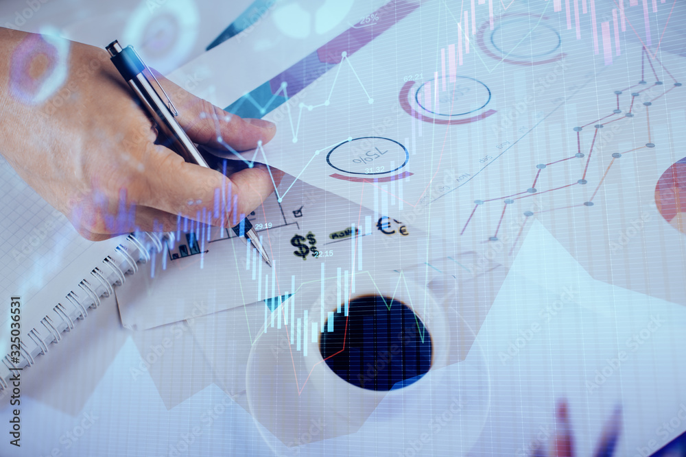 Multi exposure of man planing investment with stock market forex chart. Multi exposure of man planing investment with stock market forex chart.