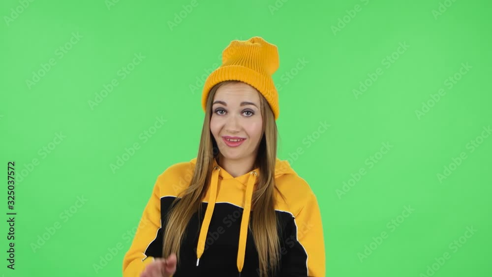 Portrait of modern girl in yellow hat is clapping her hands with dissatisfaction. Green screen Portrait of modern girl in yellow hat is clapping her hands with dissatisfaction. Green screen