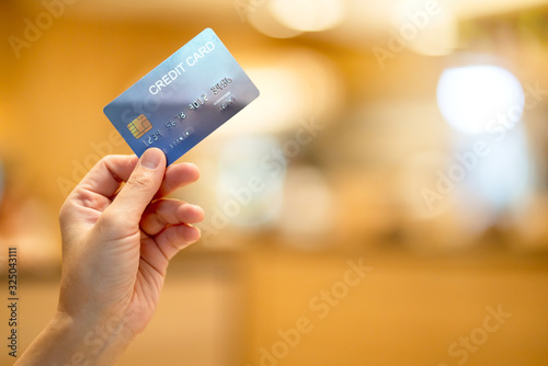 business shopping merchant ideas concept Close up of woman hand holding credit card for shopping with abstract blur mall background
