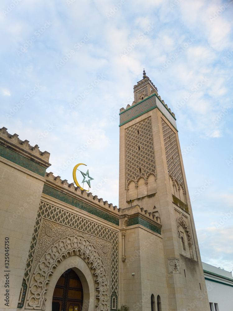 Grand Mosque of Paris (The Great Mosque of Paris), 5th arrondissement, France. The minaret from a low-angle shot. Beautiful architecture. Crenellated balustrade.