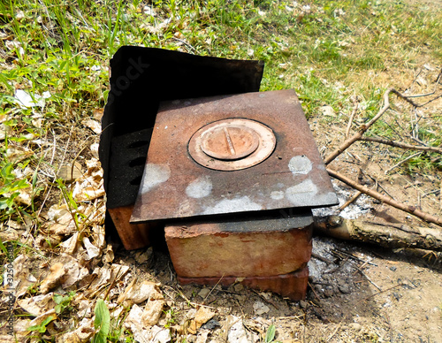 Seasonal outdoor activities, barbecue meat close-up. Drava in the stove on the coals. Nearby is a wood stove